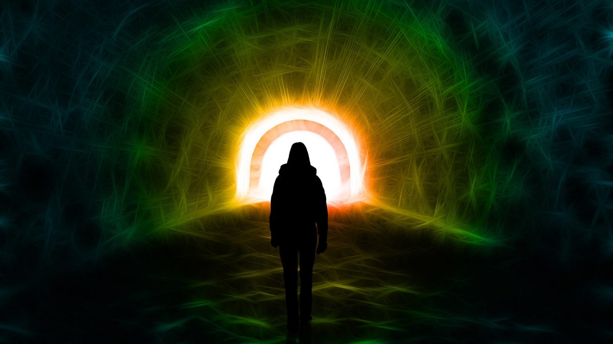 man in a tunnel with light shining at the end of the tunnel