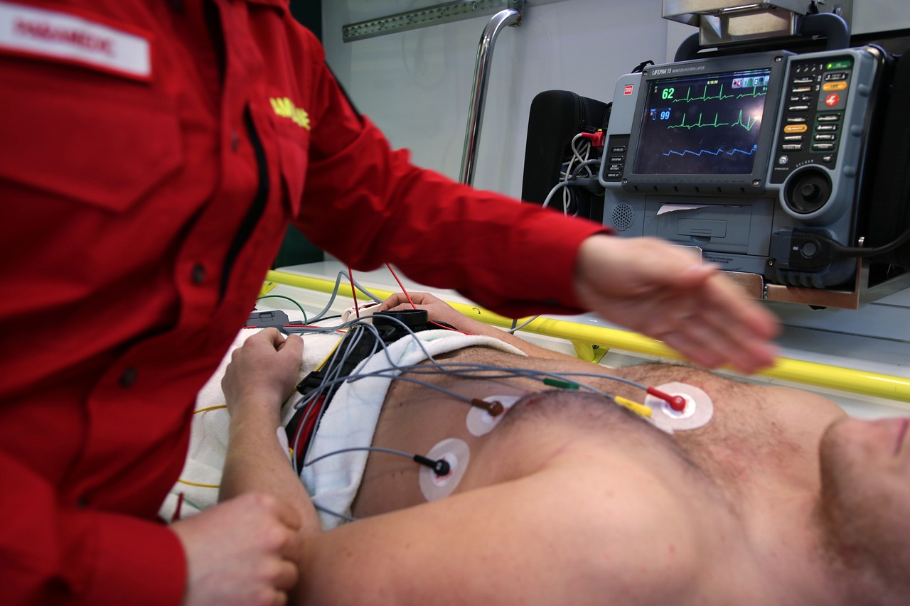 Man in an ambulance wired up to an ECG machine.